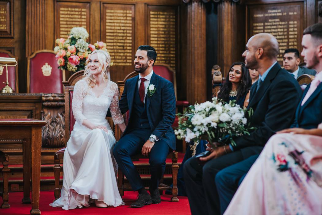 bride and groom sitting in islingston town hall ceremony