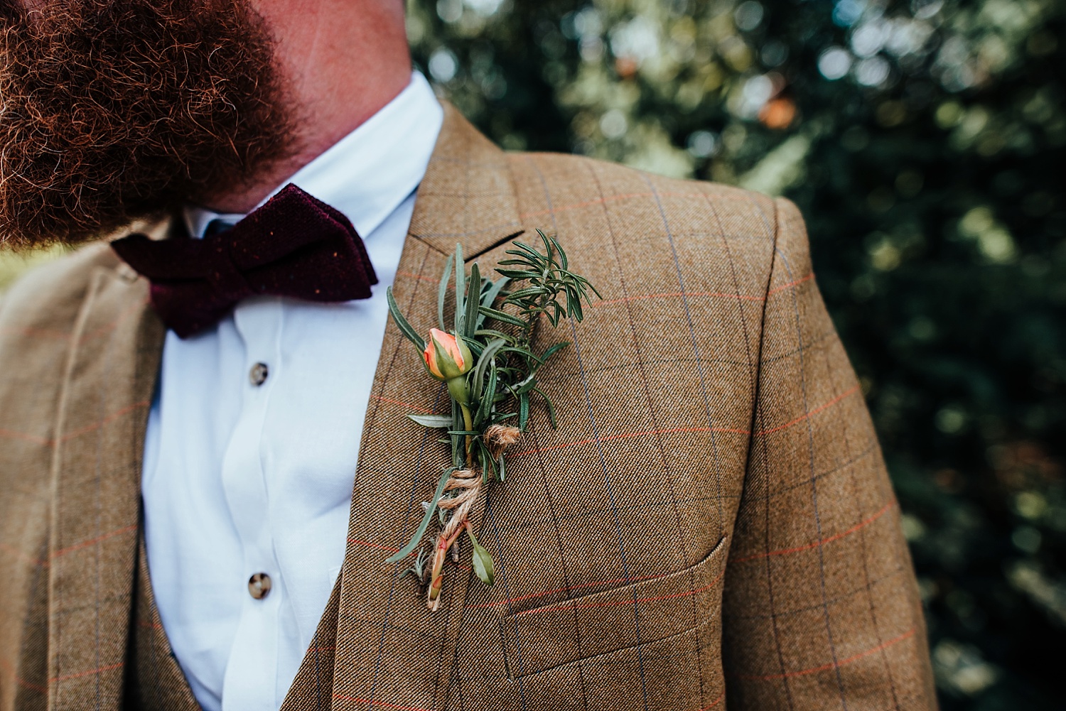 grooms buttonhole on brown tweed suit