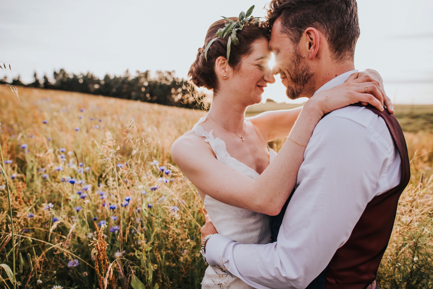 bride with flower crown and groom standing in wildflower field at huntstile organic farm